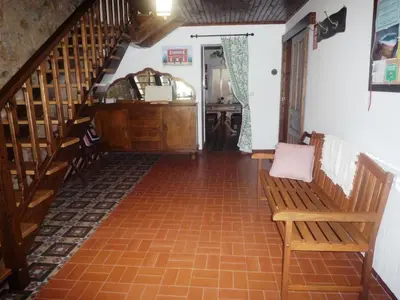 a hallway with a staircase and a bench in a house at Albergue-Hostel Casa da Gandara in Boimorto