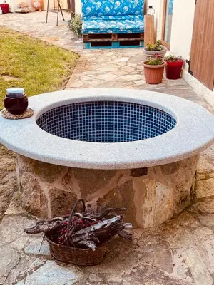 a large stone bench sitting on a patio at Albergue-Hostel Casa da Gandara in Boimorto