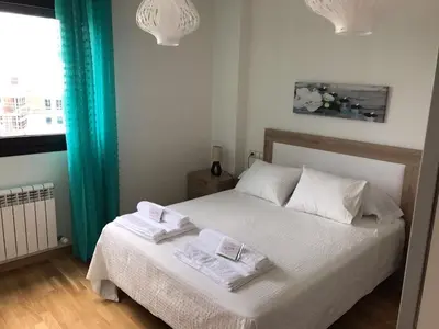 a bedroom with a bed with two towels on it at Alojamiento La Rosaleda in Ponferrada