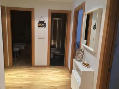 a bathroom with a toilet and a mirror at Alojamiento La Rosaleda in Ponferrada