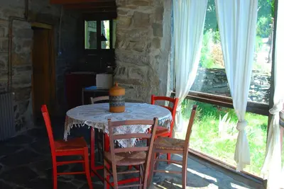 a table and chairs in a room with a window at MIL MADREÑAS ROJAS in Salientes