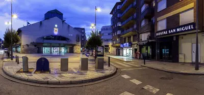 an empty street in a city at night at San Miguel in Ponferrada