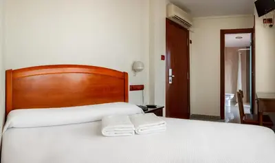 a bedroom with a bed with two towels on it at San Miguel in Ponferrada