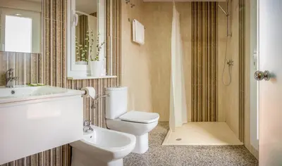 a bathroom with a toilet and a sink and a shower at San Miguel in Ponferrada