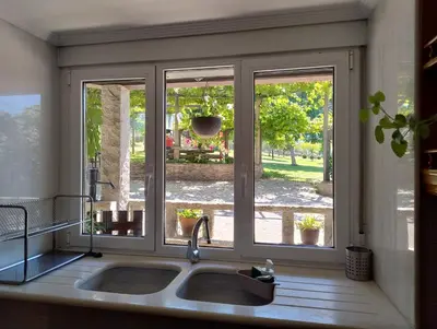 a kitchen with a sink and a window at Casa Bartulo in Castrofeito