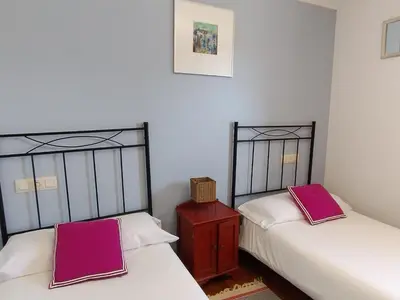two beds sitting next to each other in a room at Casa Bartulo in Castrofeito