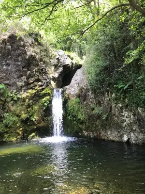 a waterfall in the middle of a pool of water at Apartamentos Las Fuentes in Castropol