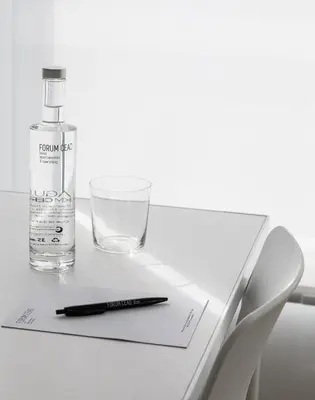a bottle of alcohol and a glass on a table at Apartamentos Forum Ceao in Lugo