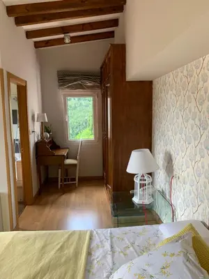 a bedroom with a bed and a desk and a window at O Remanso Dos Patos in Penalba