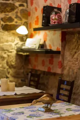 a table with a bird sitting on top of it at O Remanso Dos Patos in Penalba