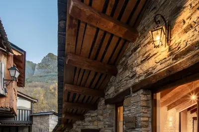 a stone building with a wooden ceiling at Fogar Mozárabe in Peñalba de Santiago