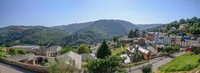 a small town in the mountains with houses and a street at A Casoa in Santa Eulalia de Oscos