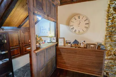 a large clock on the wall of a room at A Casoa in Santa Eulalia de Oscos