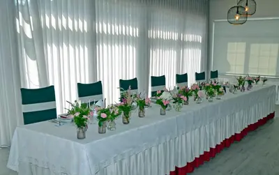 a long table with vases of flowers on it at Hostal La Casilla in Guitiriz
