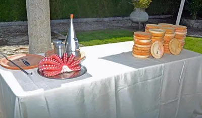 a white table with a plate of food on it at Hostal La Casilla in Guitiriz