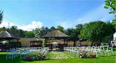 an outdoor wedding with white chairs and a gazebo at Hostal La Casilla in Guitiriz