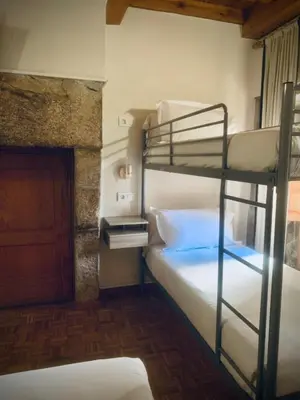 a bedroom with two bunk beds in a room at Hostal As Margaritas in Santiago de Compostela