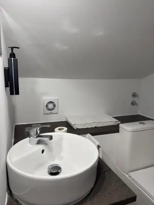 a bathroom with a white sink and a toilet at Hostal As Margaritas in Santiago de Compostela