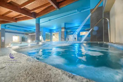 a hotel room with two beds and a desk at Hotel Spa Norat Torre Do Deza 4* Superior in Lalín