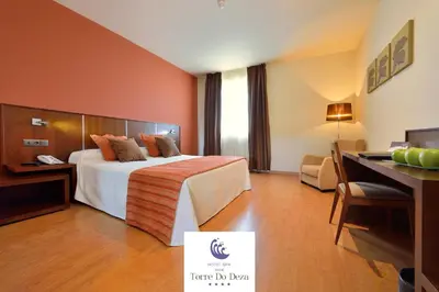 a hotel room with a bed and a desk at Hotel Spa Norat Torre Do Deza 4* Superior in Lalín