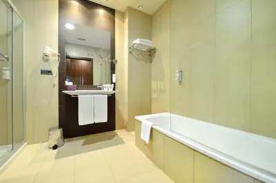 a hotel room with a bed with a phone and a plant at Hotel Spa Norat Torre Do Deza 4* Superior in Lalín