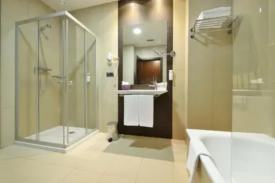 a bathroom with a tub and a sink and a mirror at Hotel Spa Norat Torre Do Deza 4* Superior in Lalín