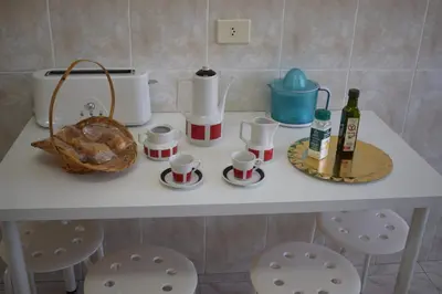 a table with cups and bottles of wine on it at La Casa de Manuel in Portomarin