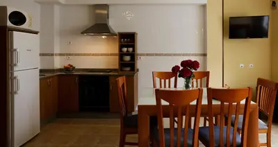 a kitchen and dining room with a table and chairs at Viviendas Turisticas Tapia in Tapia de Casariego