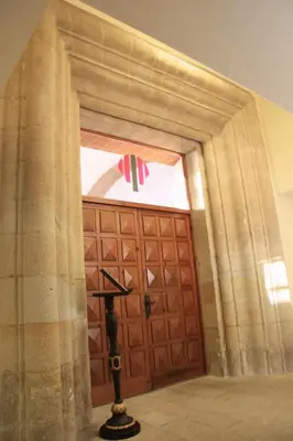 a large wooden door with a cross in front of it at Hospedería San Martín Pinario in Santiago de Compostela