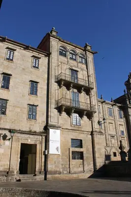 a large brick building with balconies on the side of it at Hospedería San Martín Pinario in Santiago de Compostela