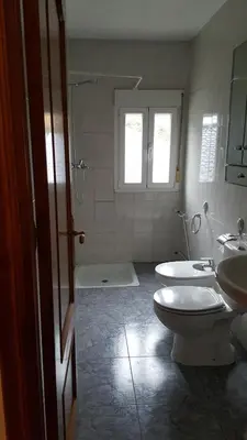 a bathroom with two sinks and a toilet and a shower at Casa de Forno in Queijadoiro