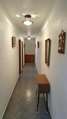 a hallway with a table in a room with a hallwayngthngthngthngthngth at Casa de Forno in Queijadoiro
