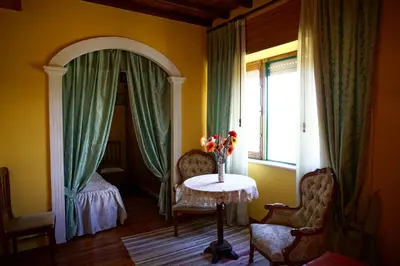 a room with a table and chairs and a window at Casa Maricuelo in Castropol