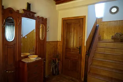 a hallway with a wooden door and a staircase at Casa Maricuelo in Castropol