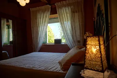 a bedroom with a bed and a large window at Casa Maricuelo in Castropol