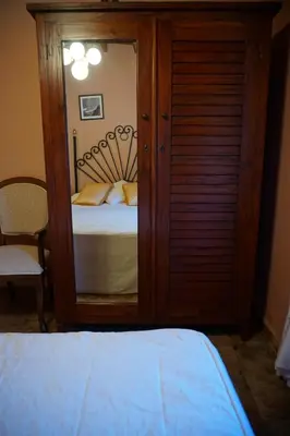 a bedroom with a bed and a large mirror at Casa Maricuelo in Castropol