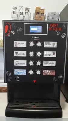 a machine with a heart of coffee on top of it at Hotel Playa de las Catedrales in Reinante