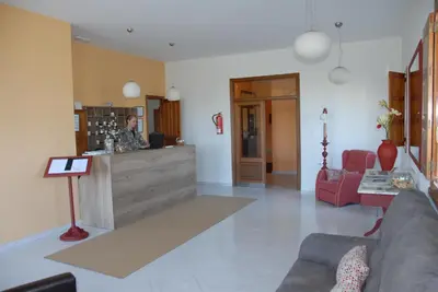 a living room with a couch and a counter at Hotel Playa de las Catedrales in Reinante