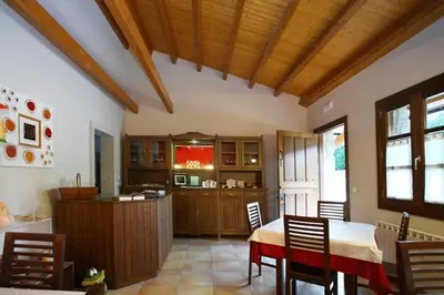 a kitchen and dining room with a table and chairs at Hotel Rústico Casa Franco in Adelán