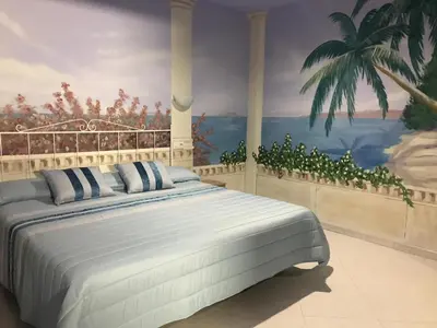 a bedroom with a large bed with a painting on the wall at Hotel O Camiño in O Barco de Valdeorras