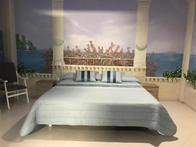 a bedroom with a bed with a painting on the wall at Hotel O Camiño in O Barco de Valdeorras