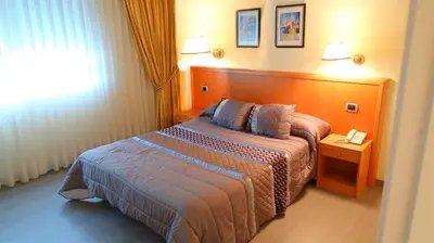 a hotel room with a bed and a window at Hotel O Camiño in O Barco de Valdeorras