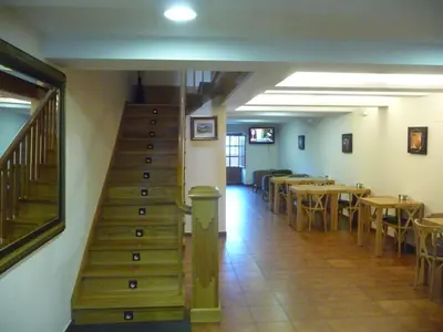 a staircase in a restaurant with tables and chairs at Hortas P.R. in Santiago de Compostela