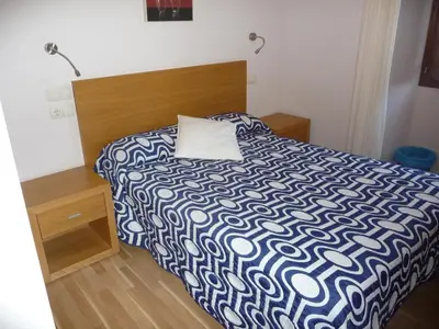 a bedroom with a bed with a pillow on it at Hortas P.R. in Santiago de Compostela