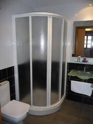 a bathroom with a shower with a toilet and a sink at Hortas P.R. in Santiago de Compostela