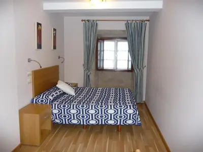 a bedroom with a bed and a window at Hortas P.R. in Santiago de Compostela