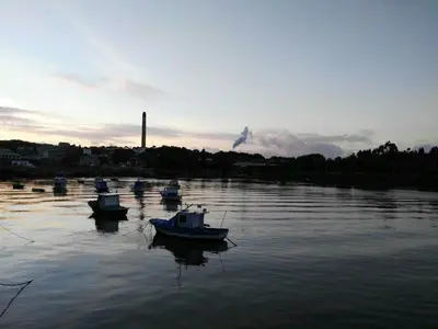 a group of boats sitting in the water at San Ciprian Atico Playa by I Love Norte in San Ciprián
