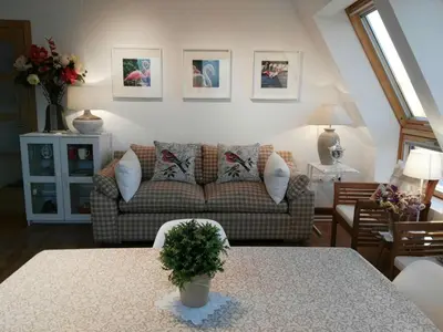 a living room with a couch and a table at San Ciprian Atico Playa by I Love Norte in San Ciprián