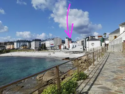 a kite flying over a beach with buildings at San Ciprian Atico Playa by I Love Norte in San Ciprián