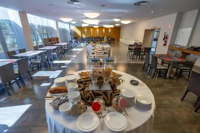 a long table with plates of food on it at Hotel Ciudad de Ponferrada, Ascend Hotel Collection in Ponferrada